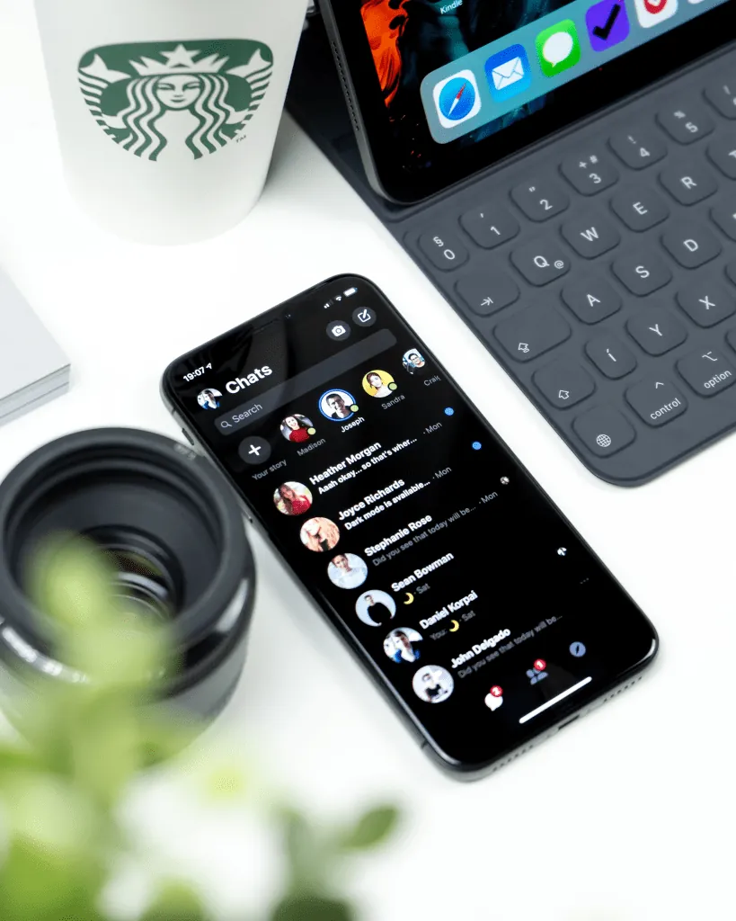 Smartphone with team chats on a manager's desk