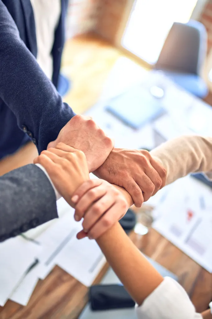Team members joining hands